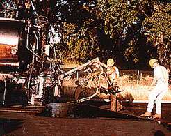 Custom apparatus in lowered position for roll loading